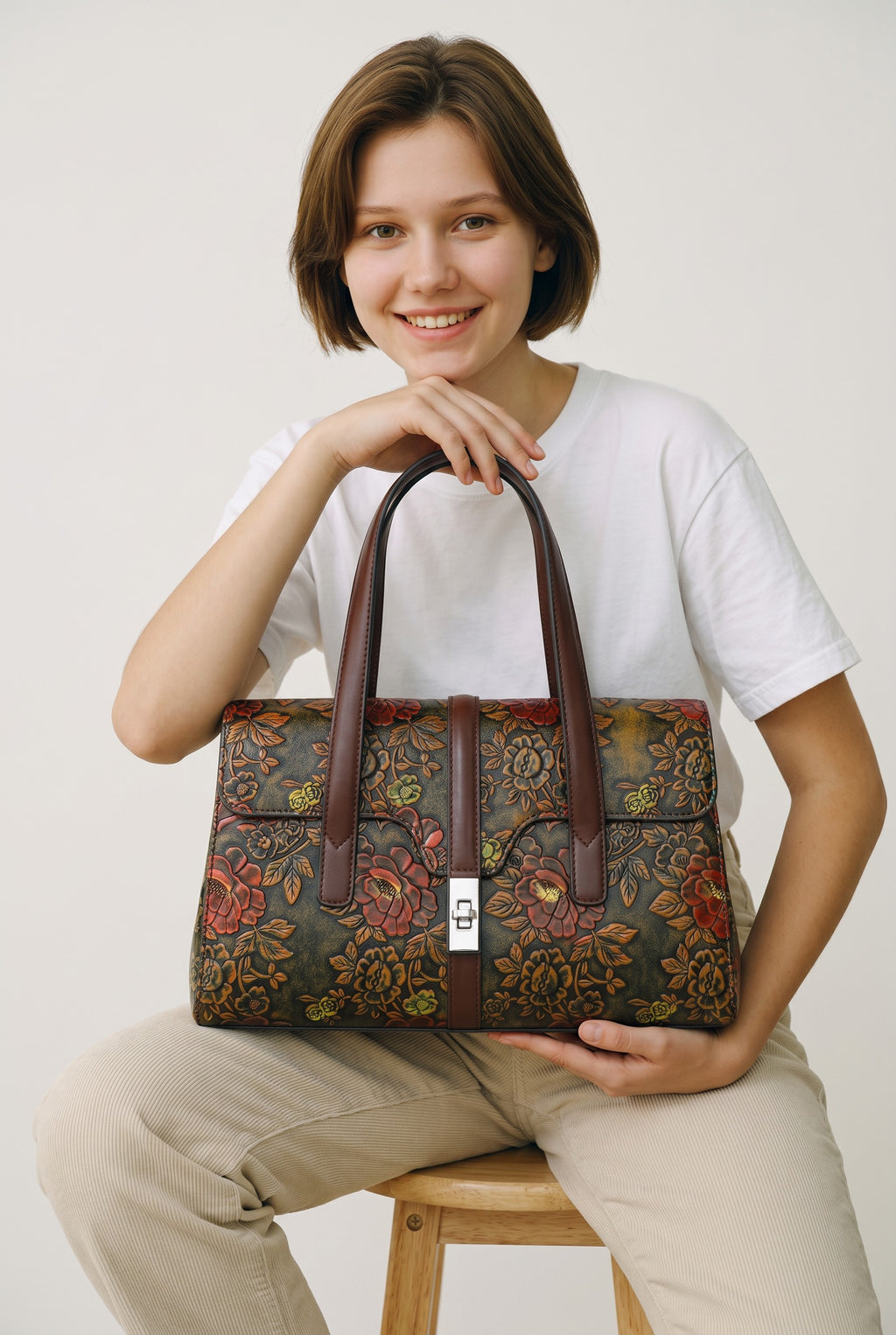 Adan & Co. coffee PU leather handbag with vintage floral embossed pattern and silver clasp.