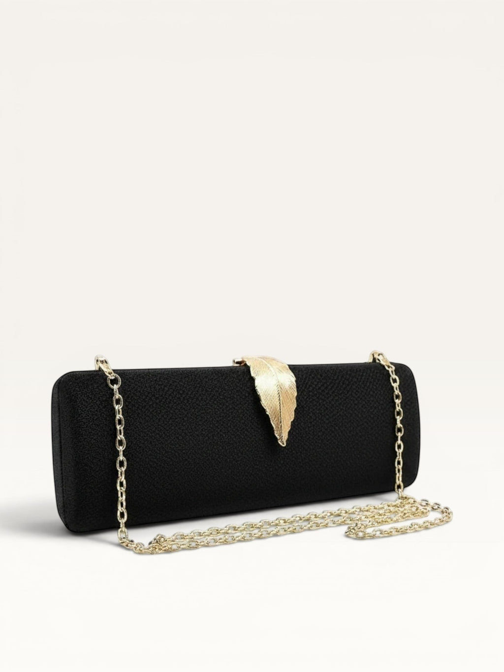 Adan & La black velvet clutch bag with gold leaf clasp and chain strap. Hard, rectangular shape with internal pockets.