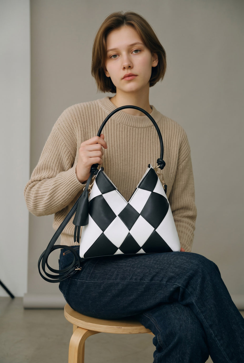 Adan & La Niche Woven Patchwork Bag in black and white PU leather with a horizontal square shape and single strap.